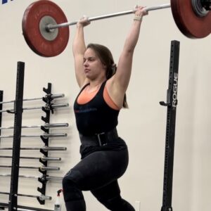Female performing clean and jerk