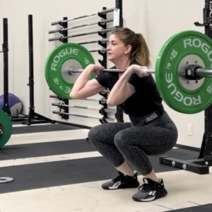 Woman performing front squat with barbell