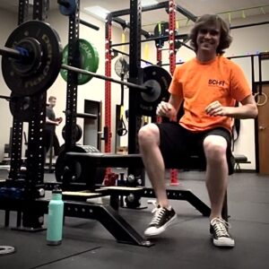 Man sitting on bench press smiling