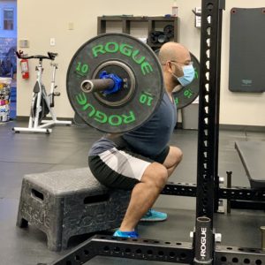 Man performing barbell squat