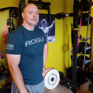 Colin standing in his home gym