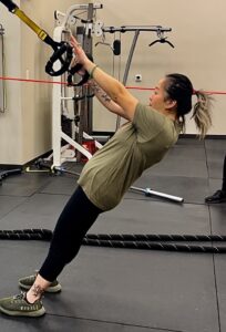 Woman performing TRX row