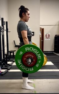 Woman performing barbell deadlift
