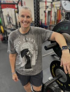 Woman leaning against a power rack