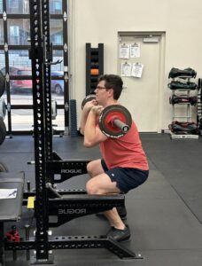 Man doing front squat with barbell
