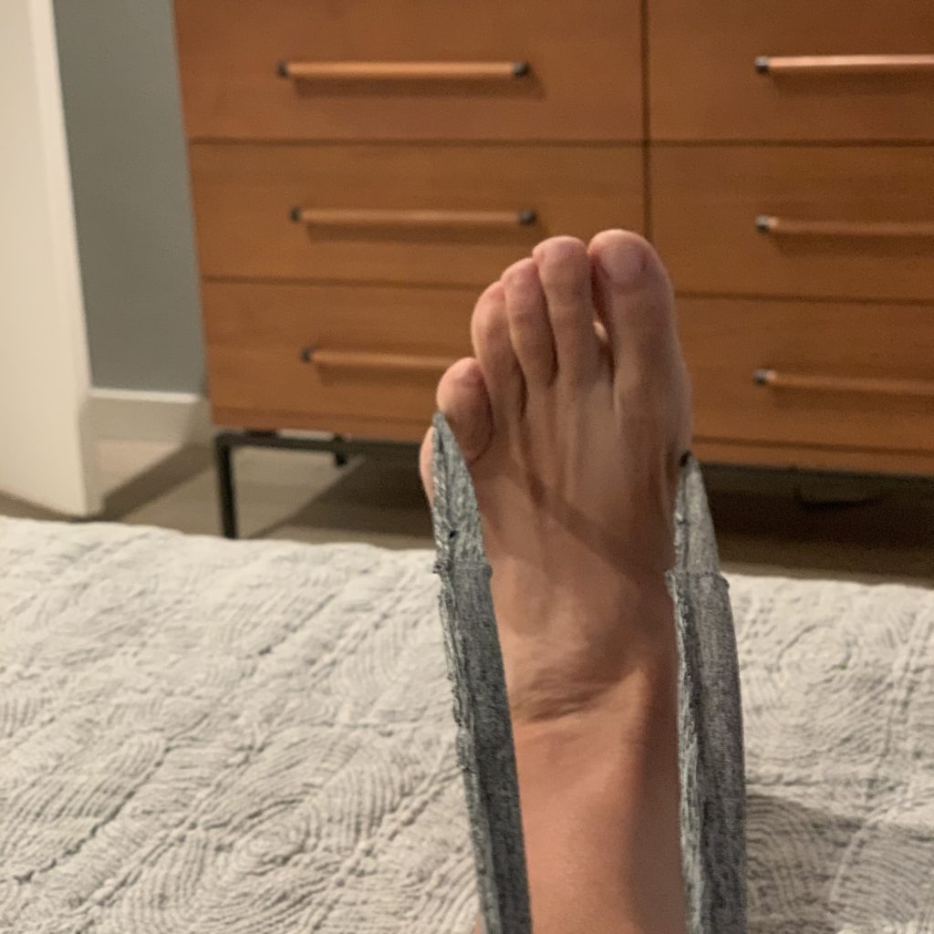 Stretching foot and calf with loop from old tee