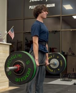 Teenager performing a barbell deadlift