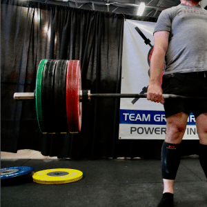 Male deadlifting barbell